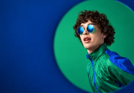 Creative portrait composed with green and blue circular forms